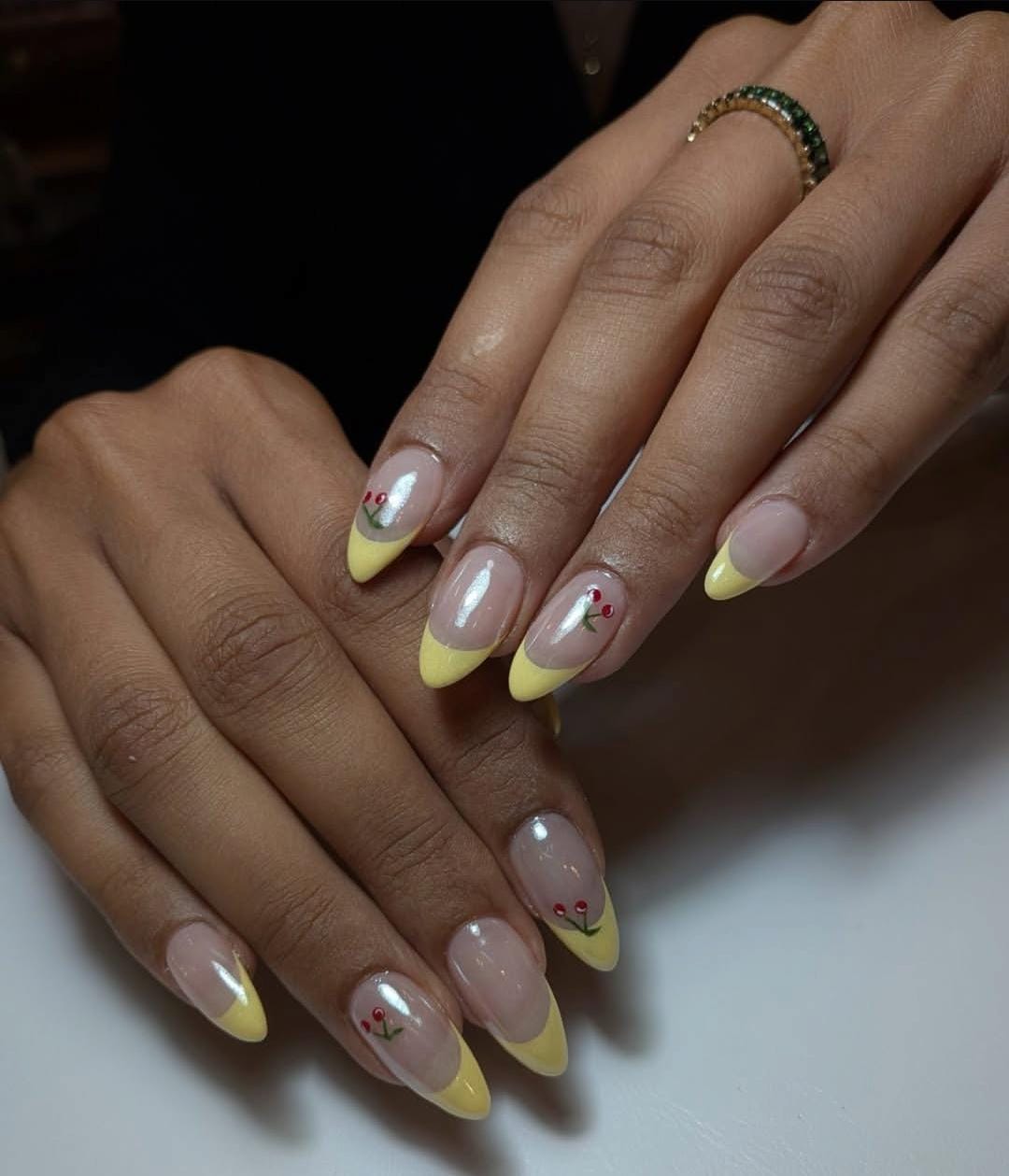 Almond nails with pastel yellow French tips and cherry art by Eilish Bratz