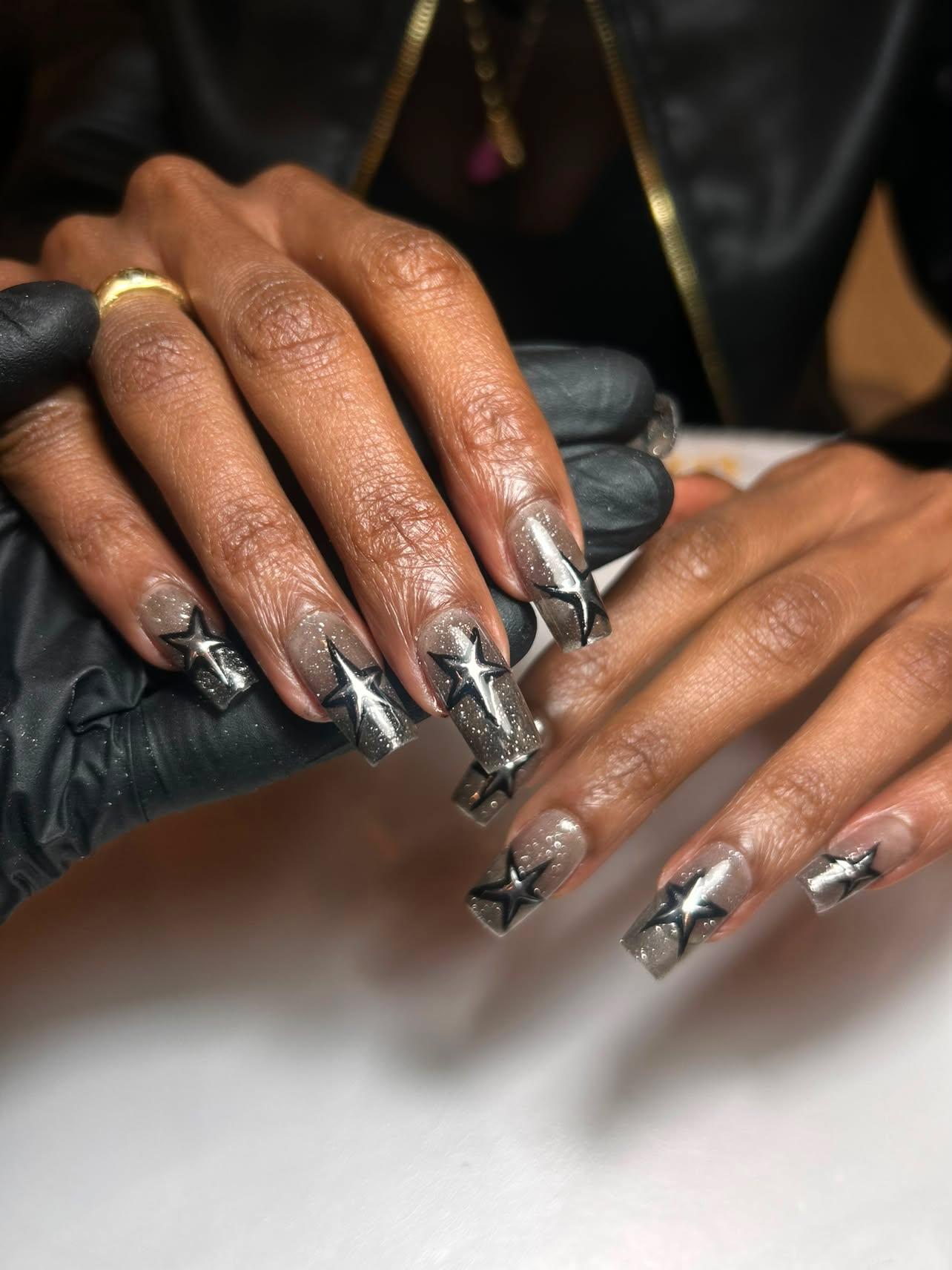Long square grey chrome nails with black star art by Eilish Bratz