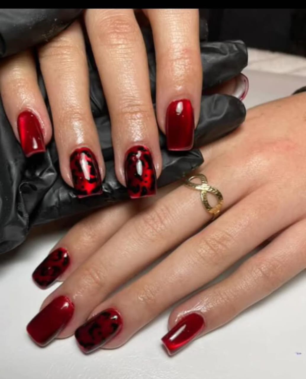 Deep red square nails with black leopard print art by Eilish Bratz