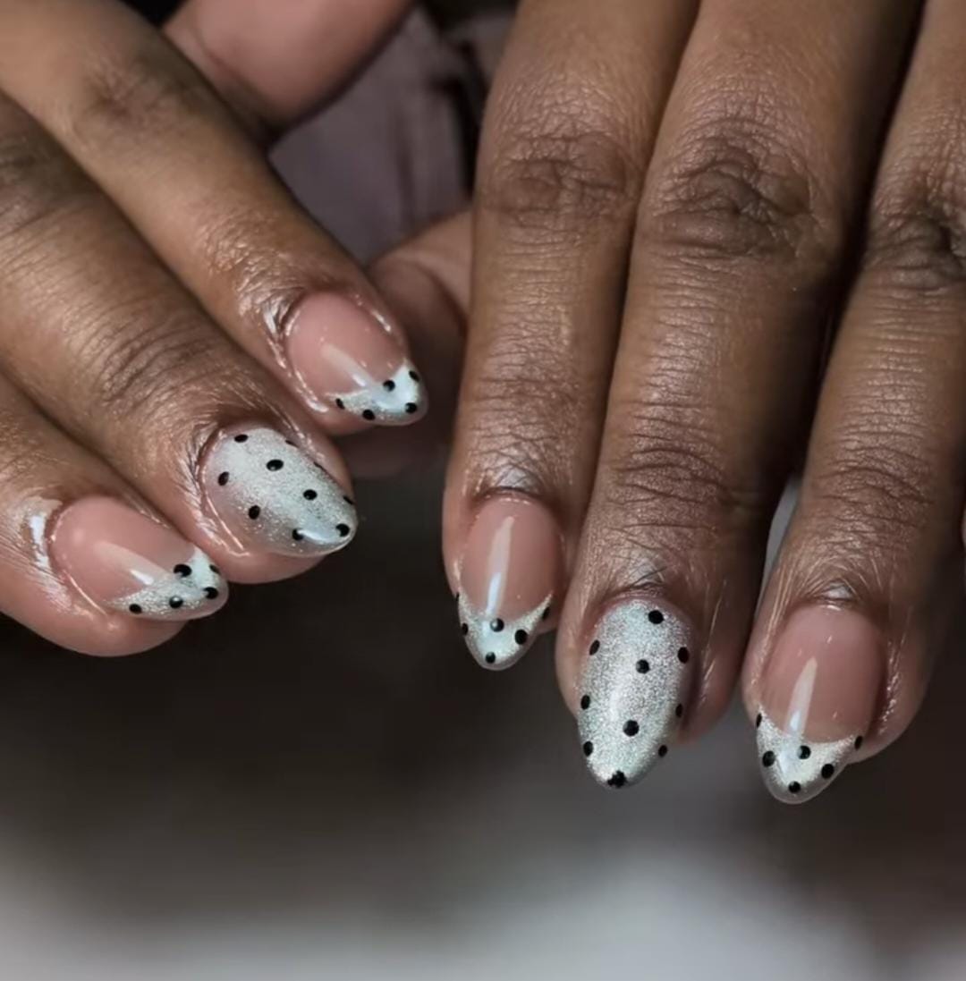 Short almond nails with glitter French tips and black polka dots by Eilish Bratz