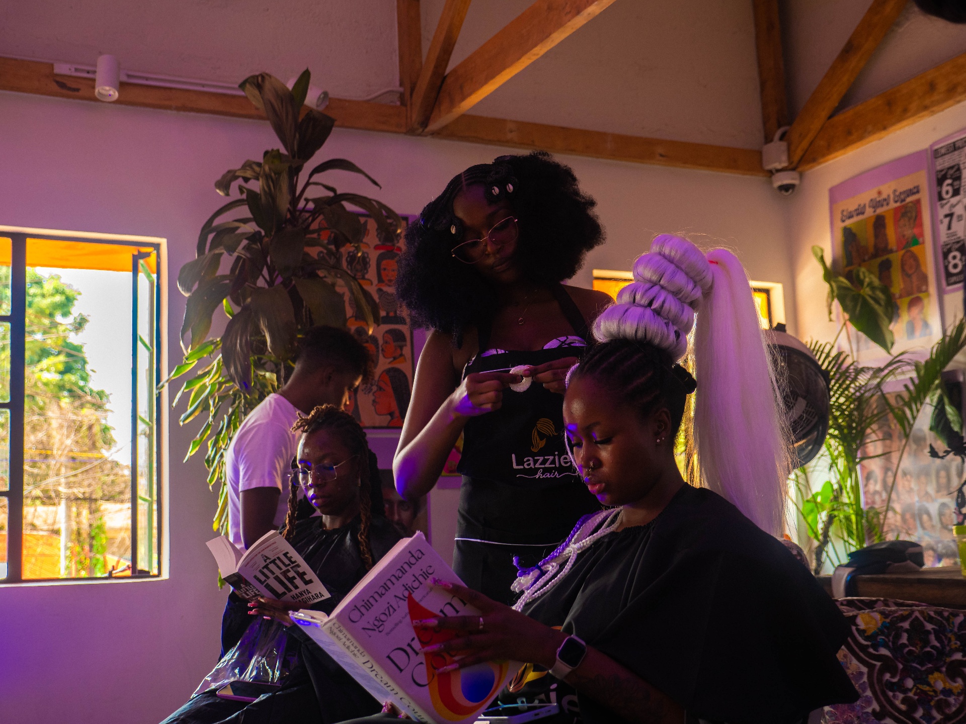 Braider working at Lazzie Hair studio during the Braiding Nairobi event